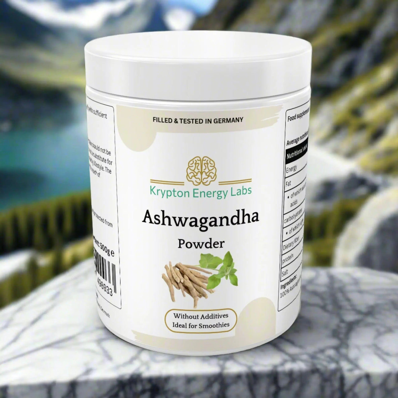 A jar of Ashwagandha Powder from Krypton Energy Labs is placed on a marble surface outdoors, set against a picturesque backdrop of mountains and a lake. Filled and tested in Germany, this additive-free powder is perfect for smoothies, aiding in stress reduction and enhancing athletic performance.