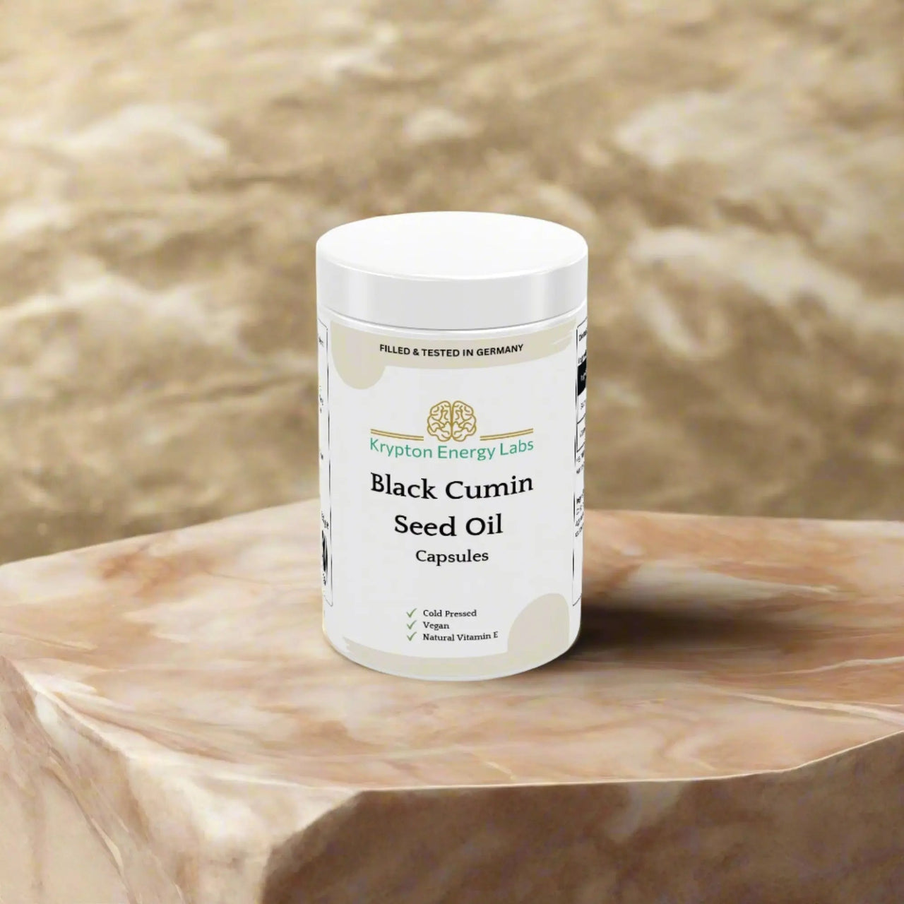 A white container marked "Black Cumin Seed Oil" by Krypton Energy Labs sits on a marble surface. The packaging emphasizes "Filled & Tested in Germany," "Cold Pressed," "Vegan," and "Natural Vitamin E." Boasting an antioxidant-rich blend with anti-inflammatory properties, the design showcases accents of gold and green.