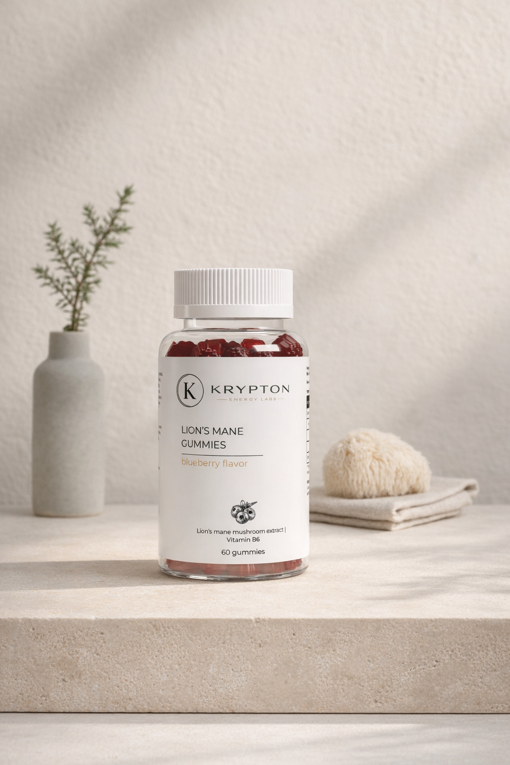Lion's Mane Gummies — Krypton Energy Labs, photographed in a Nordic apothecary still-life with travertine, soft directional morning light, and a dried Lion's Mane mushroom motif.