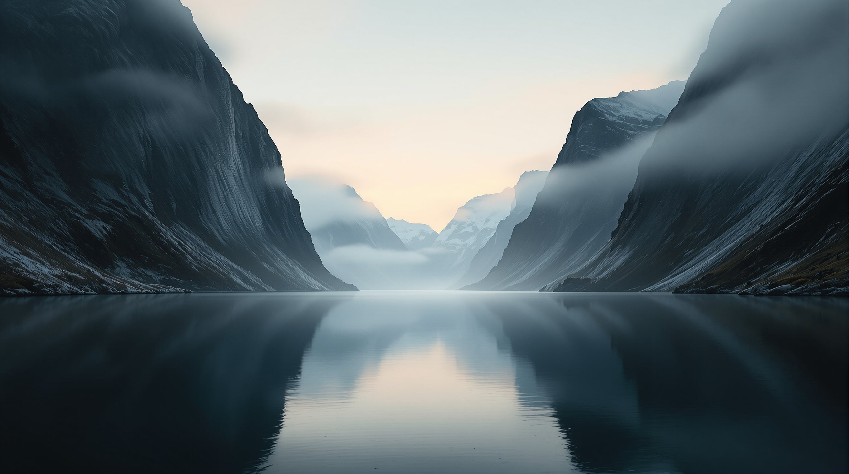 A Nordic fjord at dawn — mist drifting between mountain walls, still water reflecting the first warm light. The brand's origin geography and pace.